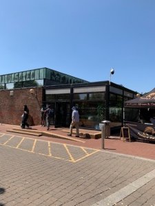 A single story brick building with a glass entrance foyer.